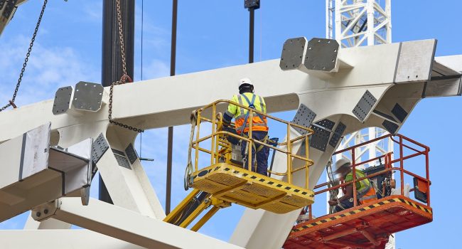 Workers on a construction site. Engineering and architectural infrastructure. Safety